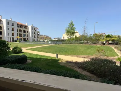 a view of a park with a lawn and buildings at Gardens Dubai by FHR in Vilamoura