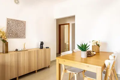 a dining room with a wooden table and chairs at BeGuest Summer Breeze in Vale Parra in Galé