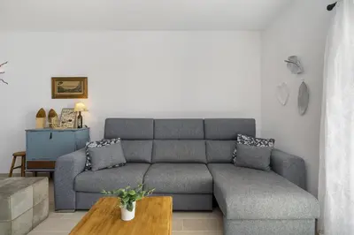 a living room with a couch and a table at Rosal Beach House in Albufeira
