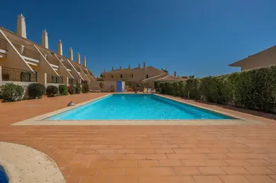 a swimming pool in the middle of a courtyard at Rosal Beach House in Albufeira