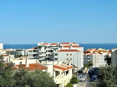 a view of a city with buildings and the ocean at Holiday Apartment Albufeira in Albufeira