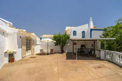 a large patio in front of a white house at Casa Solar in Guia