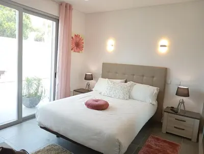 a bedroom with a large bed with a red pillow on it at Villa Luz 37 - Jacuzzi Terrace & Swimming Pool in Albufeira