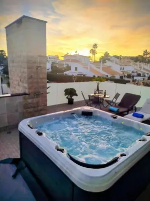 a jacuzzi tub on a patio with a view at Villa Luz 37 - Jacuzzi Terrace & Swimming Pool in Albufeira