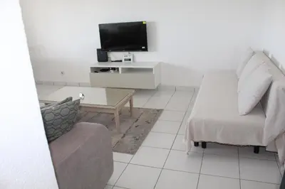 a living room with a couch and a tv at Casa Oura Sea Living in Albufeira