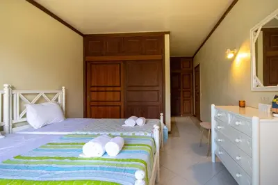 a bedroom with a bed with white towels on it at TAC - Vila Tina Vilamoura in Quarteira