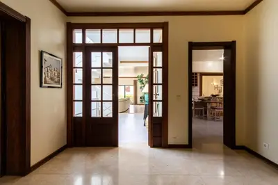 an open hallway with doors to a living room at TAC - Vila Tina Vilamoura in Quarteira