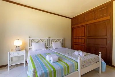 a bedroom with a bed with two towels on it at TAC - Vila Tina Vilamoura in Quarteira