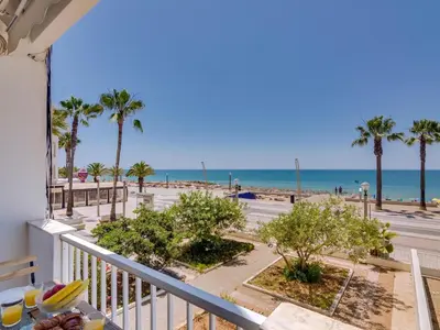 a balcony with a view of the beach at AL - Apartamento Maré Baixa in Quarteira