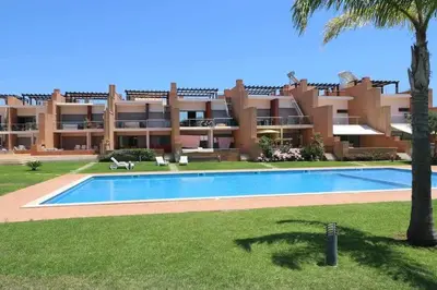 a large apartment building with a large swimming pool at Millennium golf by FHR piscina & parking in Vilamoura