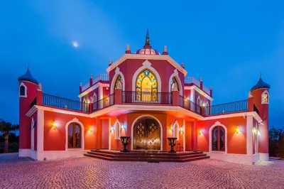 a large red building with a balcony on top at Quinta do Galvao - Luxury Villa by HD PROPERTIES in Quarteira