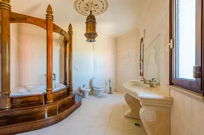 a bathroom with two toilets and a tub and a sink at Quinta do Galvao - Luxury Villa by HD PROPERTIES in Quarteira