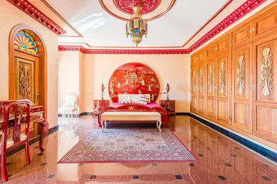 a bedroom with a bed and a chandelier at Quinta do Galvao - Luxury Villa by HD PROPERTIES in Quarteira