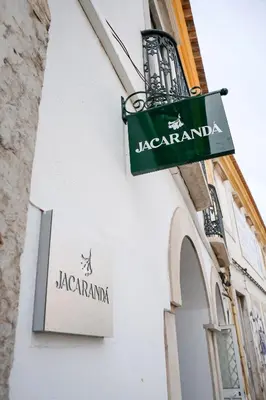 a sign on the side of a building at Guest House Jacarandá Faro in Faro