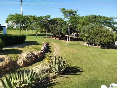 a garden with a stone path in a park at The Sun - Clube Albufeira Garden Village in Albufeira