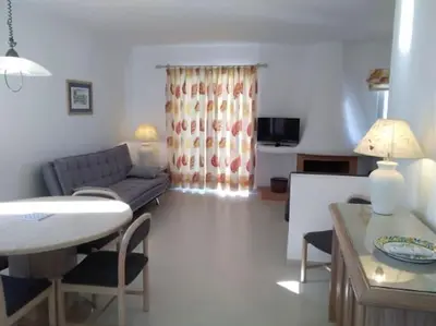 a living room with a couch and a table at The Sun - Clube Albufeira Garden Village in Albufeira