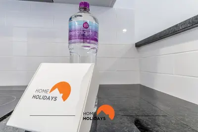 a bottle of water and a box on a counter at #169 T3 Medronheira by Home Holidays in Albufeira