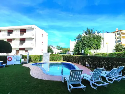 a couple of chairs and a swimming pool at Vilamoura Twins 1 With Pool by Homing in Vilamoura