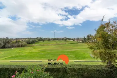 a view of a golf course with a home holdaways sign at #174 T2 em Zona Tranquila by Home Holidays in Albufeira