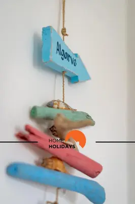 a group of surfboards hanging on a wall at #174 T2 em Zona Tranquila by Home Holidays in Albufeira
