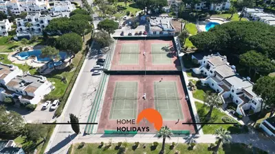 an aerial view of a house with two tennis courts at #174 T2 em Zona Tranquila by Home Holidays in Albufeira