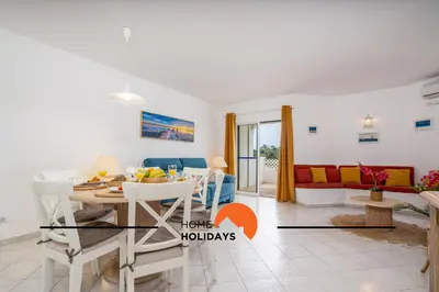 a living room with a table and a couch at #174 T2 em Zona Tranquila by Home Holidays in Albufeira