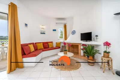 a living room with a couch and a tv at #174 T2 em Zona Tranquila by Home Holidays in Albufeira