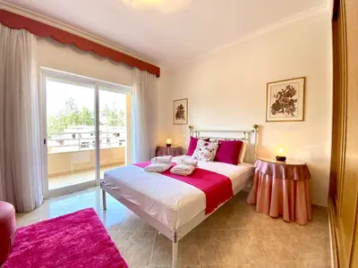a bedroom with a large bed and a large window at Vilamoura Typical 2 With Pool by Homing in Vilamoura