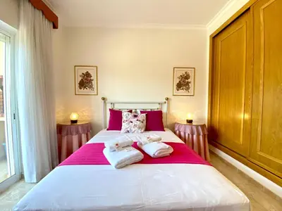 a bedroom with a large bed with towels on it at Vilamoura Typical 2 With Pool by Homing in Vilamoura
