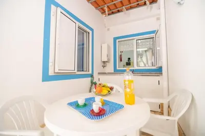 a small white table with a bowl of fruit on it at Casinha I by Innkeeper in Guia
