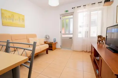 a living room with a couch and a television at Casinha I by Innkeeper in Guia