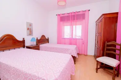 a bedroom with two beds and a window at Casinha I by Innkeeper in Guia