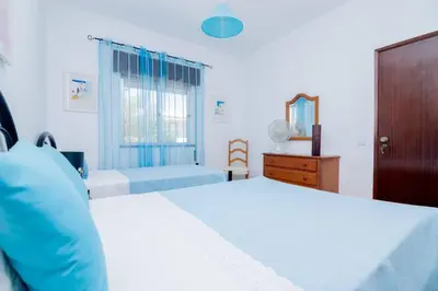 a bedroom with a large bed and a window at Casinha VII by Innkeeper in Guia