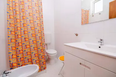 a bathroom with a toilet and a shower curtain at Casinha VII by Innkeeper in Guia