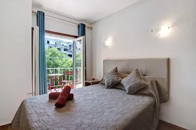 a bedroom with a large bed and a window at Hanna's Sunny Apartment in Albufeira