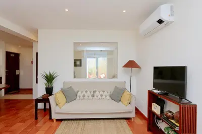 a living room with a white couch and a flat screen tv at Marina Vista Sol-CleverDetails, Marina view, sleeps 2 adults and 2 children in Vilamoura