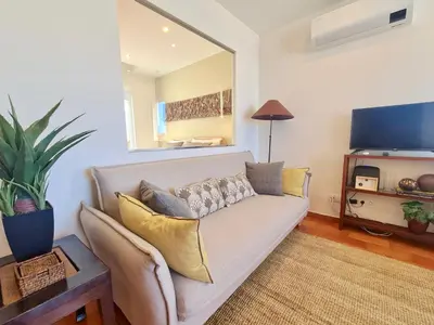 a living room with a couch and a flat screen tv at Marina Vista Sol-CleverDetails, Marina view, sleeps 2 adults and 2 children in Vilamoura