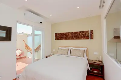 a bedroom with a white bed and a large window at Marina Vista Sol-CleverDetails, Marina view, sleeps 2 adults and 2 children in Vilamoura