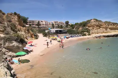 a group of people on a beach in the water at Sea Beside in Albufeira