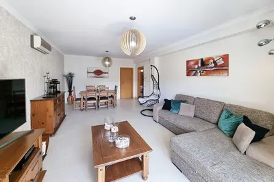a living room with a couch and a table at Sea Beside in Albufeira