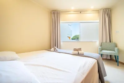 a bedroom with a bed and a window at Mourabel Apartment - S by HelloVacations in Loulé