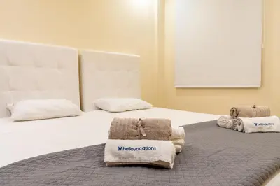 a bedroom with two beds with towels on them at Mourabel Apartment - S by HelloVacations in Loulé