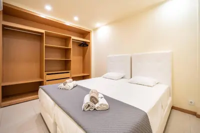 a bedroom with two beds with towels on them at Mourabel Apartment - S by HelloVacations in Loulé