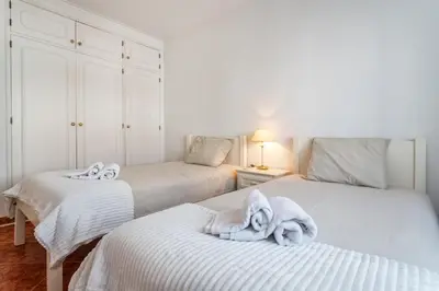 two beds with towels on them in a bedroom at Host Wise - Amazing Sunny Flat - Swimming Pool & Terrace in Vilamoura