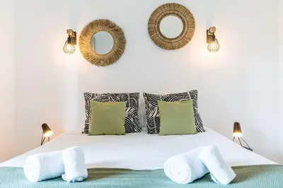 a bedroom with a bed and a large window at Villa Amour Charming Duplex Apartment on Marina in Quarteira