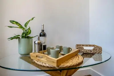 a living room with a staircase and a green couch at Villa Amour Charming Duplex Apartment on Marina in Quarteira