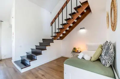 a living room with a couch and a flat screen tv at Villa Amour Charming Duplex Apartment on Marina in Quarteira