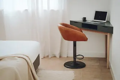 a bedroom with a desk with a chair and a laptop at CASA AMOR JACARANDA - Ocean View Modern Vila in Albufeira