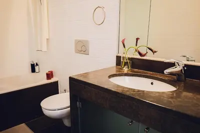 a bathroom with a sink and a toilet at CASA AMOR JACARANDA - Ocean View Modern Vila in Albufeira
