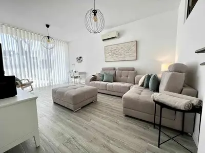 a bedroom with a bed and a couch and a window at Anzol By FHR in Quarteira